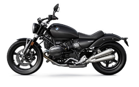 Ein klassisch gestaltetes Motorrad von BMW, schräg von der Seite fotografiert vor einem weißen Hintergrund. Das Motorrad ist komplett in Schwarz gehalten, mit Ausnahme der beiden Auspuffrohre auf der rechten Seite, die in einem metallischen Silber glänzen. Der Motor und der Rahmen sind ebenfalls schwarz.